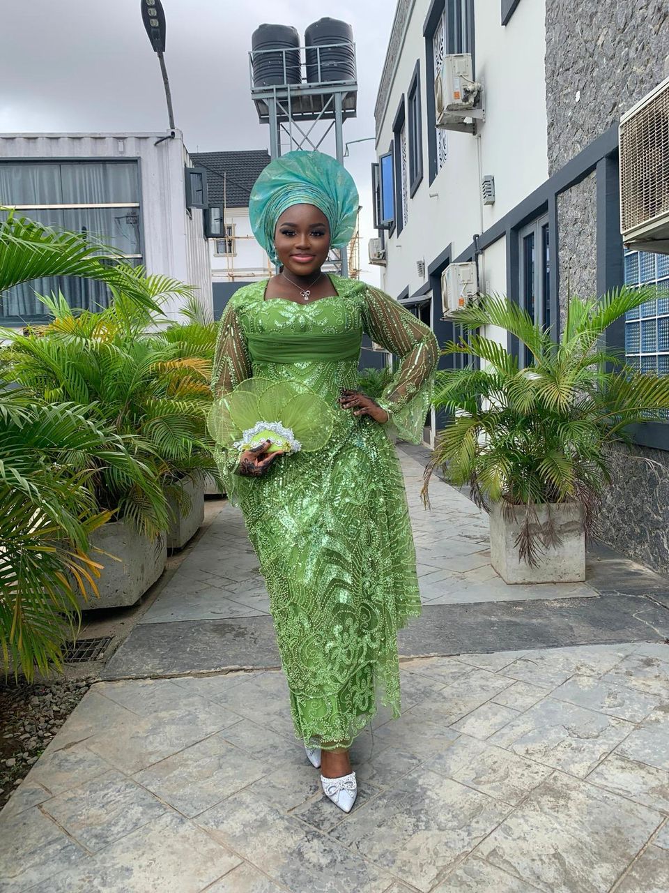 Green lace aso-ebi outfit styled for an owambe celebration.